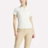 Polo de golf moulant à manches courtes et fermeture éclair pour femme