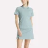 Polo de golf moulant à manches courtes et fermeture éclair pour femme