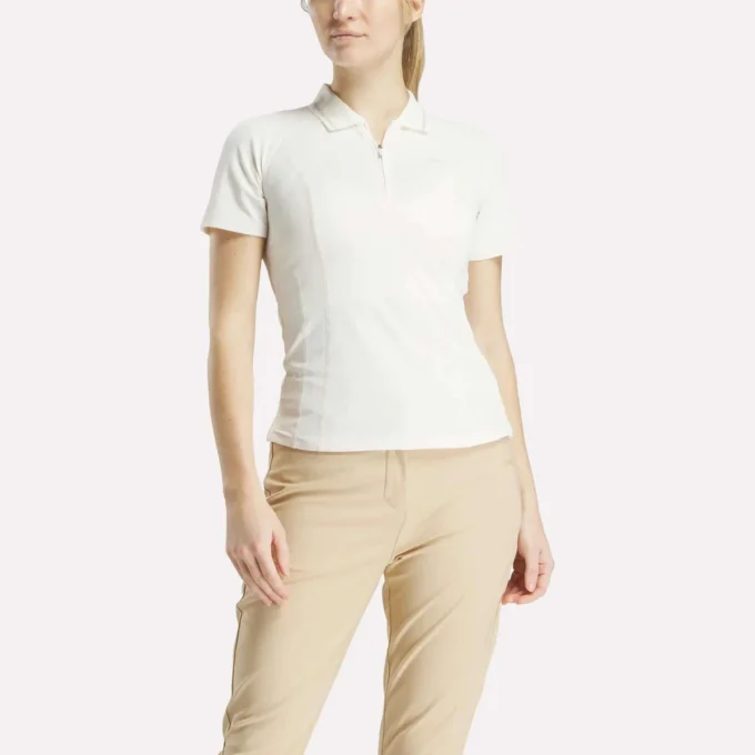 Polo de golf moulant à manches courtes et fermeture éclair pour femme