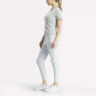 Polo de golf moulant à manches courtes et fermeture éclair pour femme