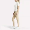 Polo de golf moulant à manches courtes et fermeture éclair pour femme