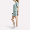 Polo de golf moulant à manches courtes et fermeture éclair pour femme