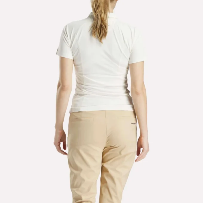 Polo de golf moulant à manches courtes et fermeture éclair pour femme