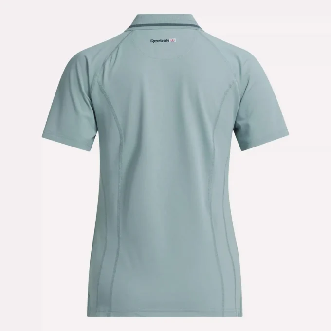 Polo de golf moulant à manches courtes et fermeture éclair pour femme