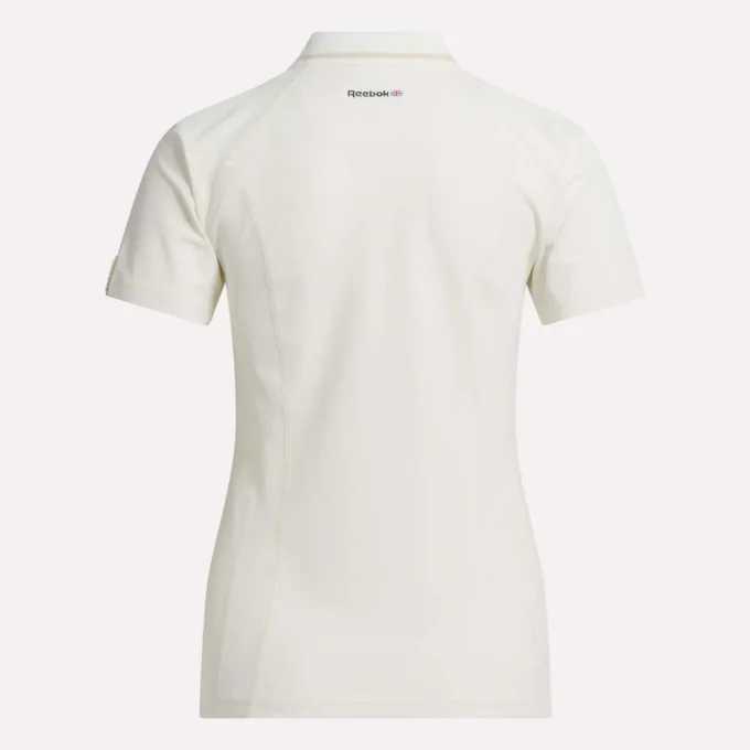 Polo de golf moulant à manches courtes et fermeture éclair pour femme