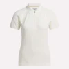 Polo de golf moulant à manches courtes et fermeture éclair pour femme