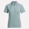 Polo de golf moulant à manches courtes et fermeture éclair pour femme