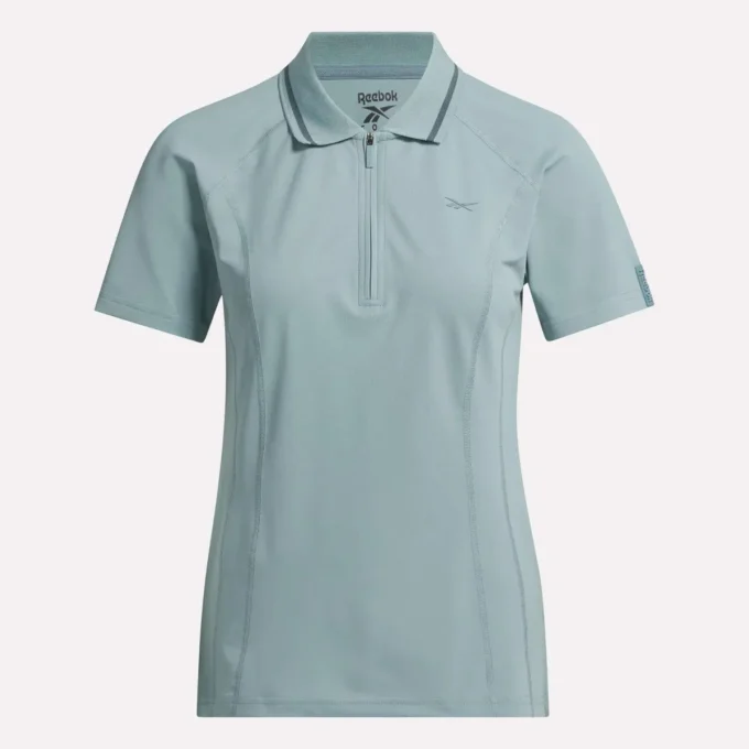 Polo de golf moulant à manches courtes et fermeture éclair pour femme